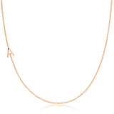 A rose gold necklace with an A letter charm on a white background. 