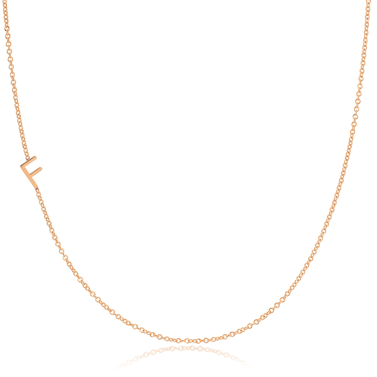 A rose gold necklace with a F letter charm on a white background. 