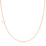 A rose gold necklace with a U letter charm on a white background. 