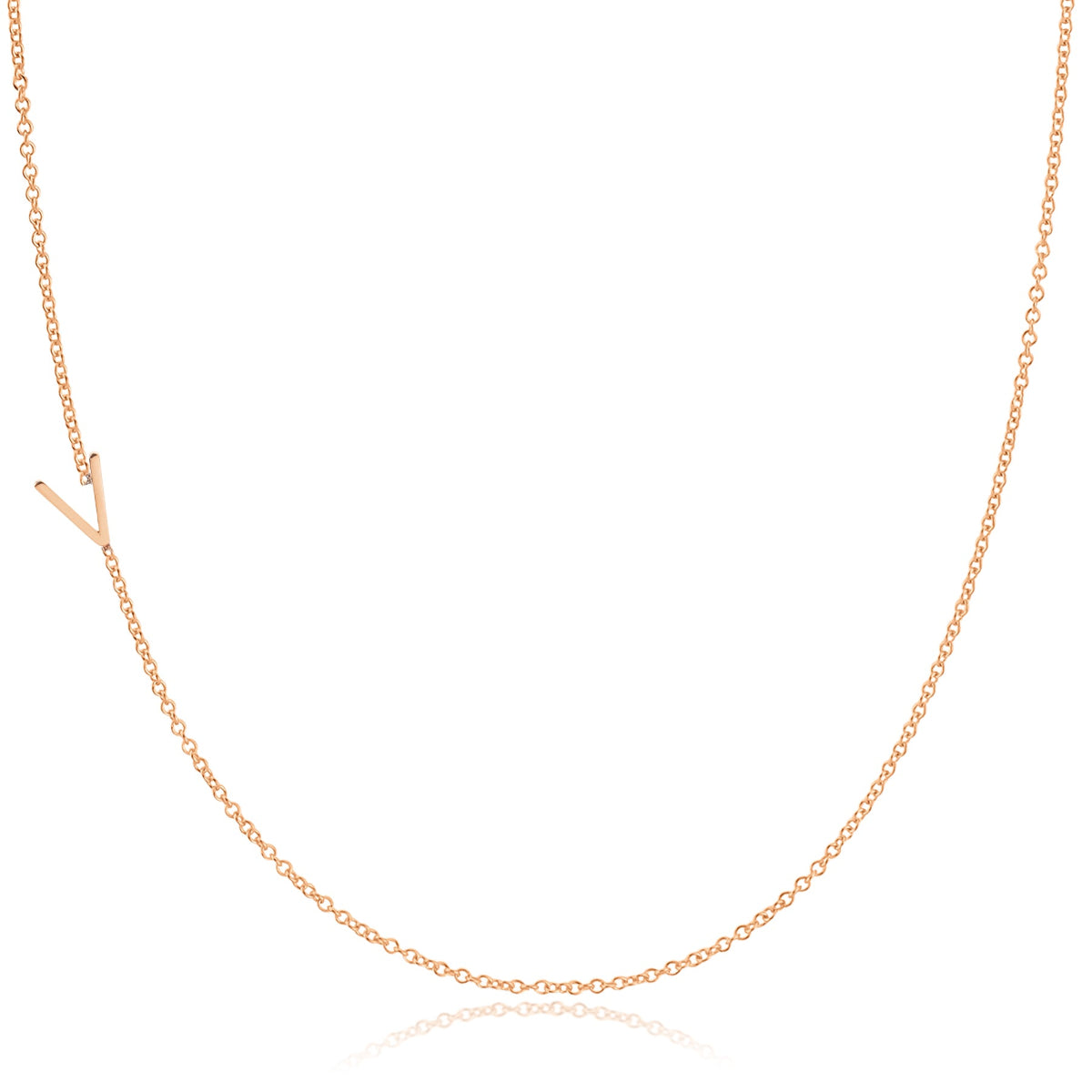 A rose gold necklace with a V letter charm on a white background. 