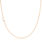 A rose gold necklace with a L letter charm on a white background. 