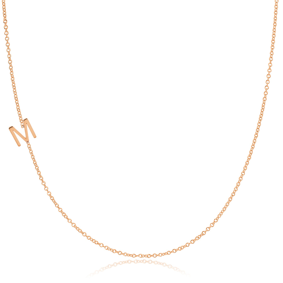 A rose gold necklace with an M letter charm on a white background. 