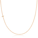 A rose gold necklace with a T letter charm on a white background. 