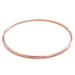 A rose gold Simple Bangle on a white background. 