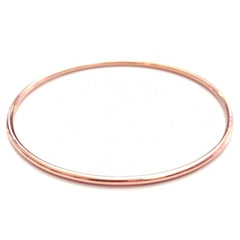 A rose gold Simple Bangle on a white background. 