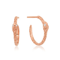 Snake Hoops in rose gold on a white background. 