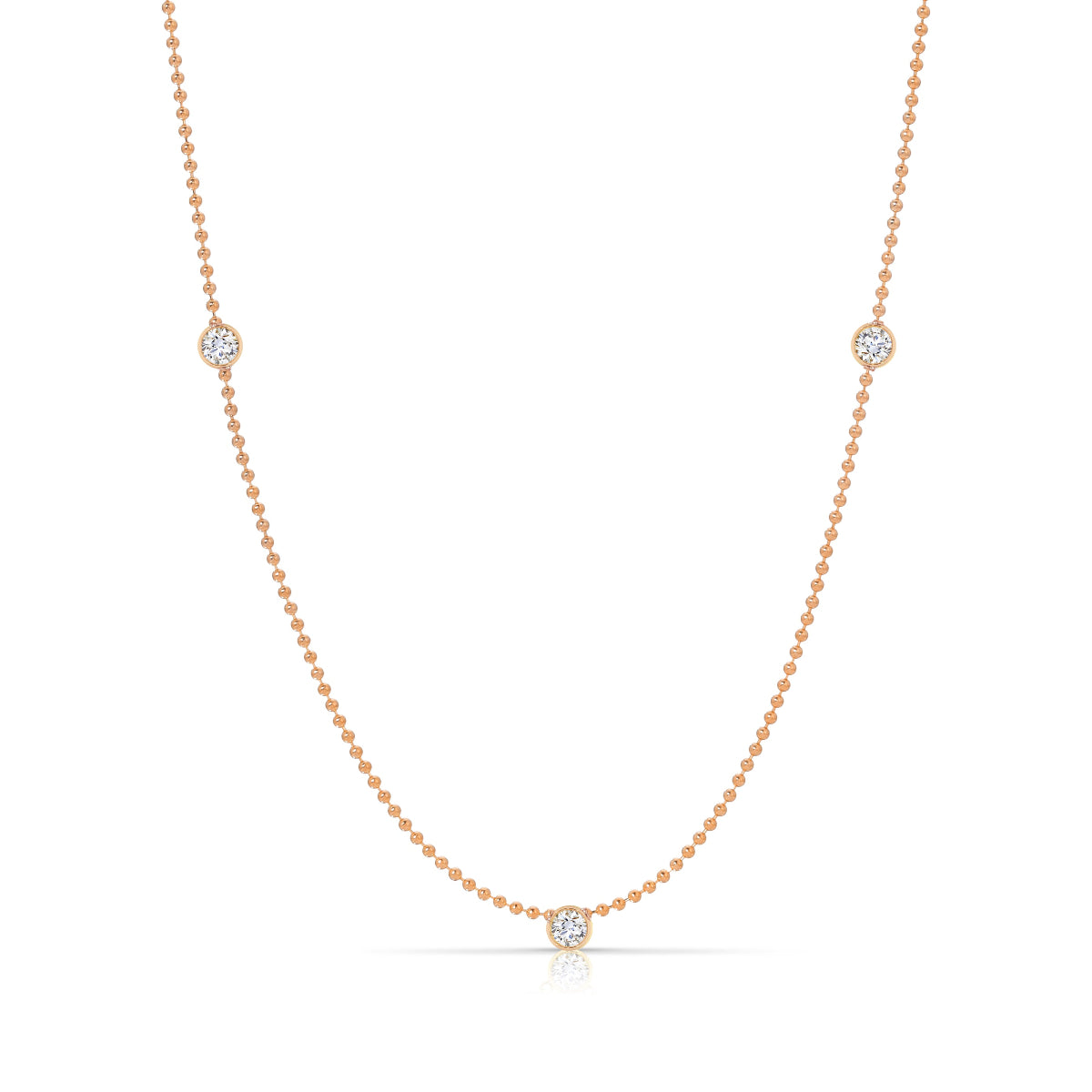 Triple Diamond Layering Necklace in rose gold on a white background. 