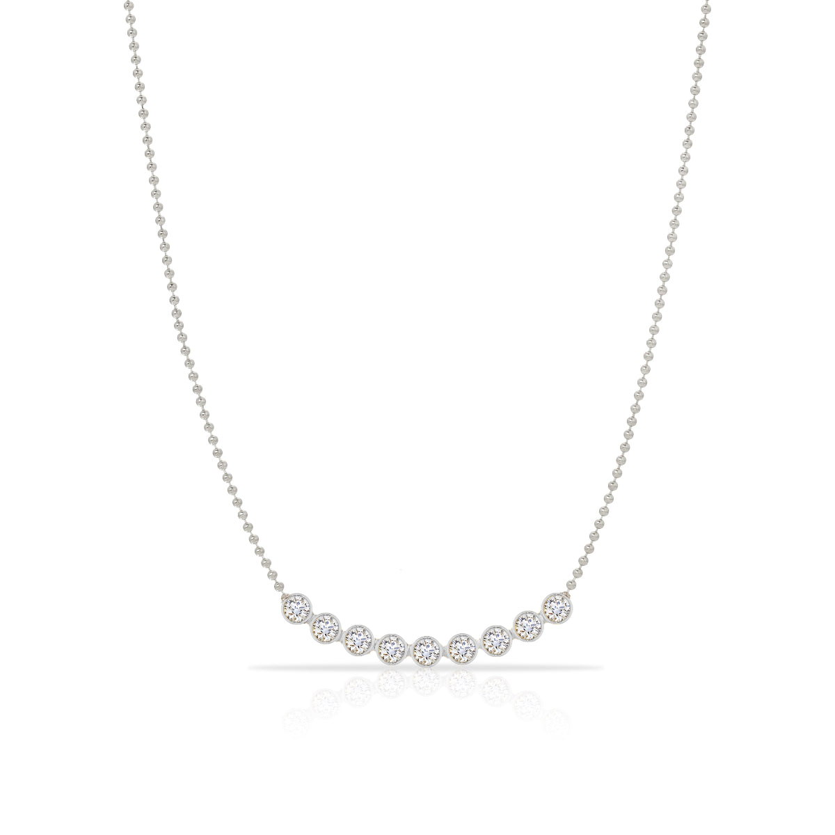 A Diamond Arc Layering Necklace in white gold on a white background. 
