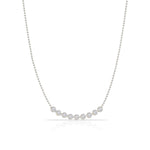 A Diamond Arc Layering Necklace in white gold on a white background. 
