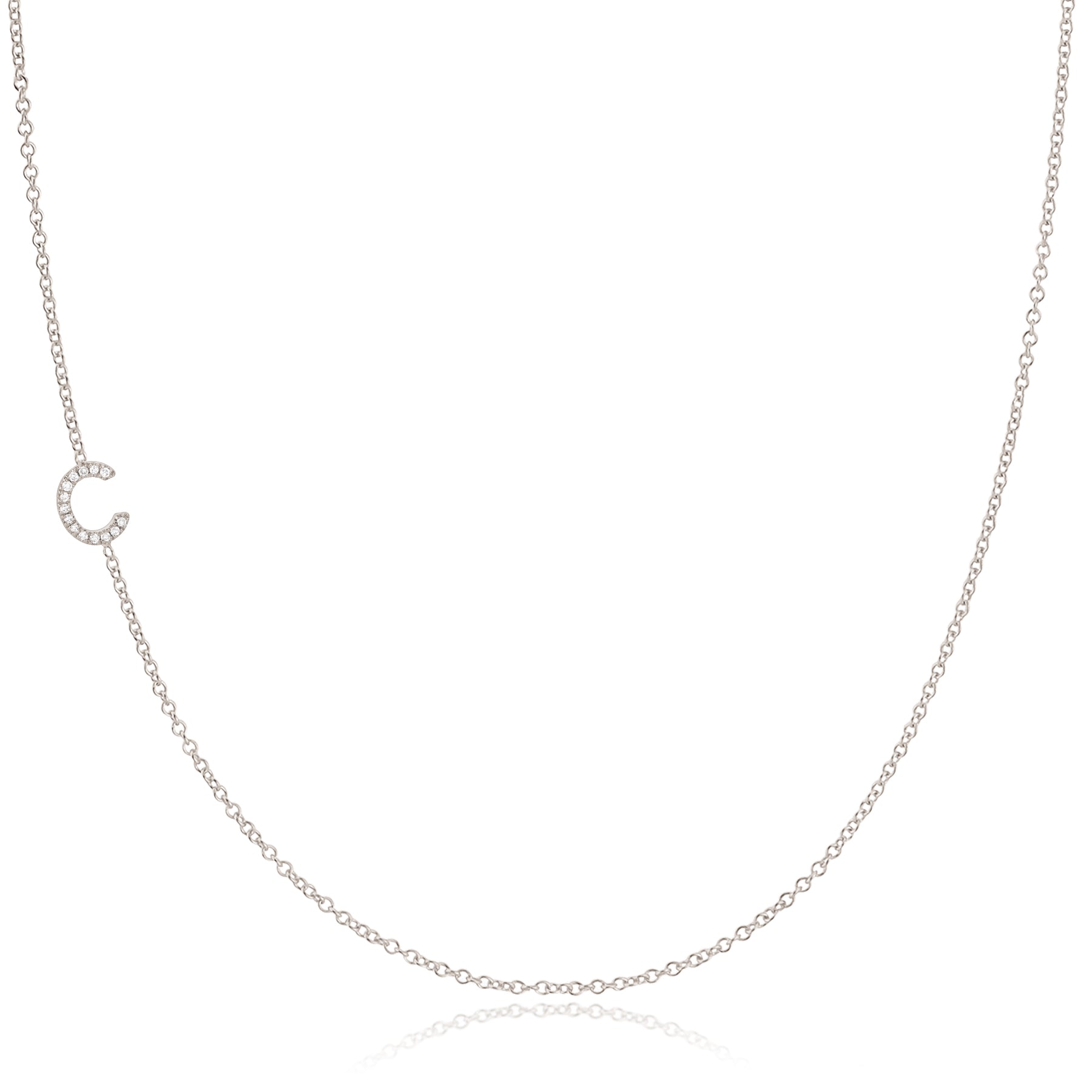 A white gold necklace with a pave letter C charm on a white background. 