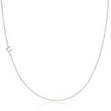 A white gold necklace with a F letter charm on a white background. 