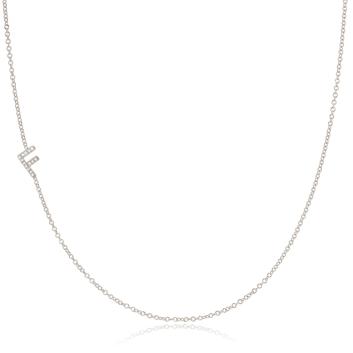 A white gold necklace with a F letter pave charm on a white background. 