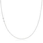 A white gold necklace with an I letter charm on a white background. 