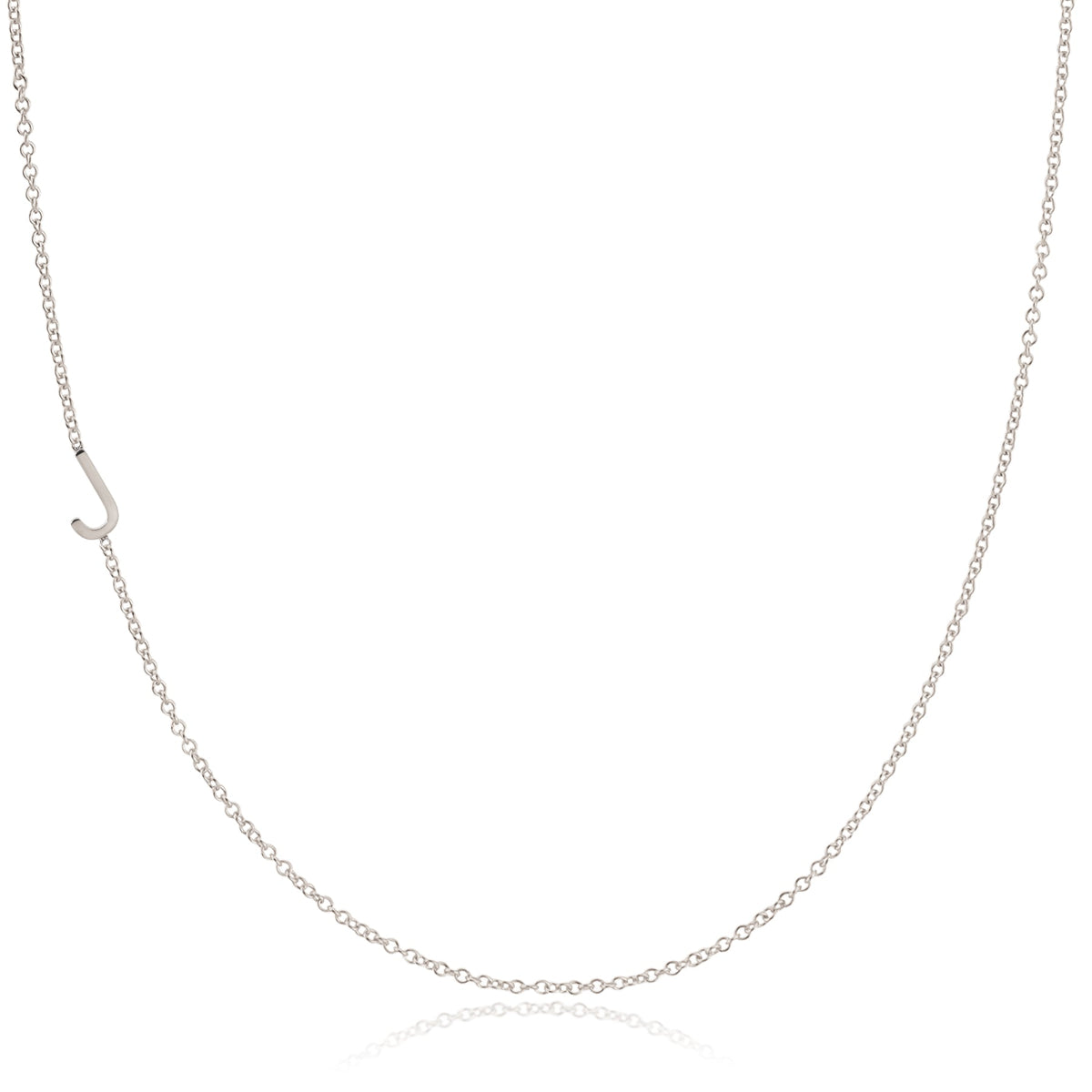 A white gold necklace with an J letter charm on a white background. 