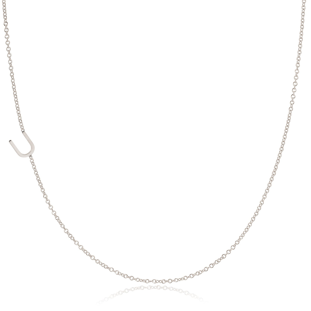 A white gold necklace with a U letter charm on a white background. 
