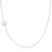 A white gold necklace with a W letter charm on a white background. 