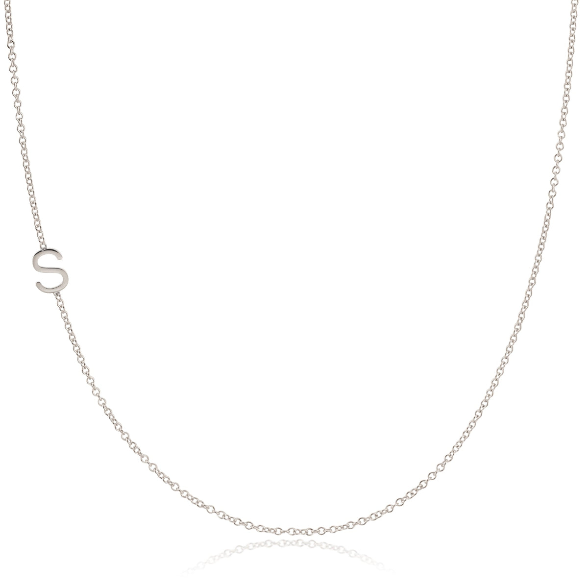 A white gold necklace with an S letter charm on a white background. 