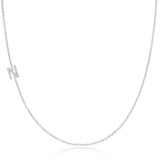 A white gold necklace with a letter N pave charm on a white background.