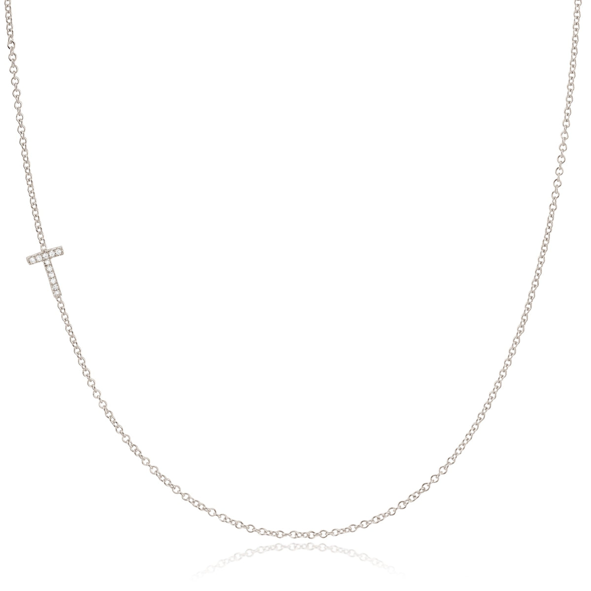 A white gold necklace with a letter T pave charm on a white background.