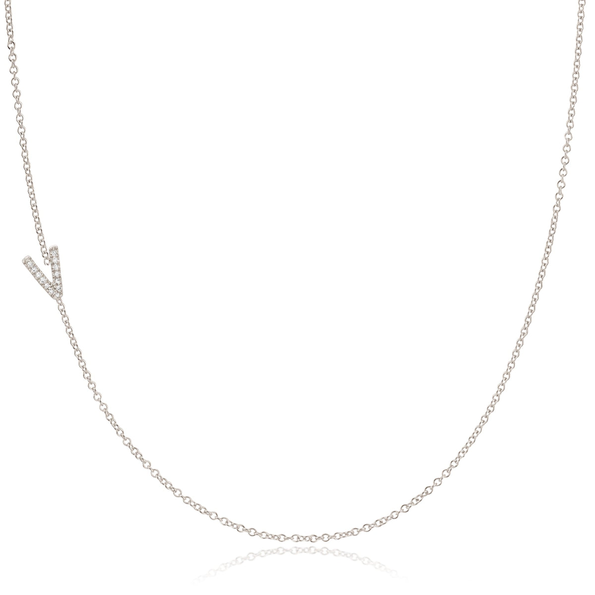 A white gold necklace with a letter V pave charm on a white background.