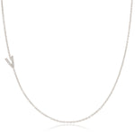 A white gold necklace with a letter V pave charm on a white background.