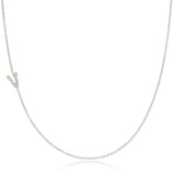 A white gold necklace with a letter V pave charm on a white background.