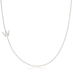 A white gold necklace with a letter W pave charm on a white background.
