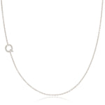 A white gold necklace with a letter Q pave charm on a white background.