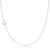 A white gold necklace with a letter Q pave charm on a white background.