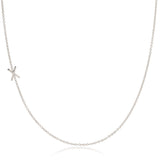 A white gold necklace with a X letter charm on a white background. 