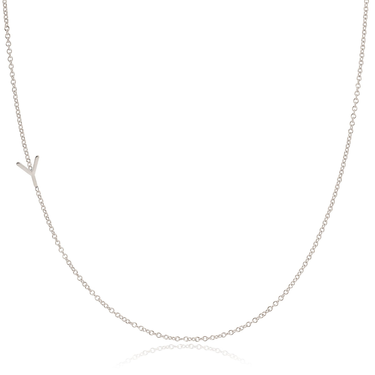 A white gold necklace with a Y letter charm on a white background. 