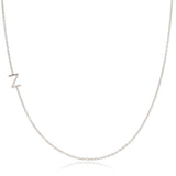 A white gold necklace with a Z letter charm on a white background. 