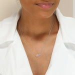 A Pavé MRS Necklace in white gold on a cable chain on a white background. 