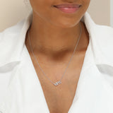 A Pavé MRS Necklace in white gold on a cable chain on a white background. 