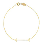 A Straight as an Arrow Bracelet in yellow gold on a white background. 