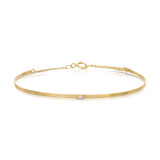 An Off the Cuff Bracelet in yellow gold on a white background. 