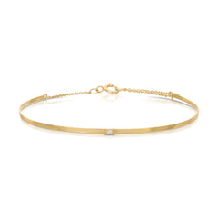 An Off the Cuff Bracelet in yellow gold on a white background. 