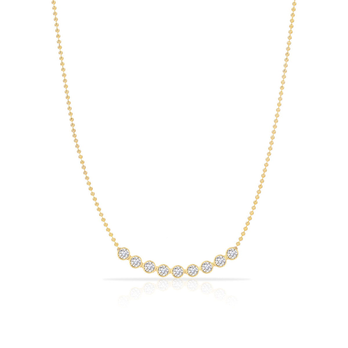 A Diamond Arc Layering Necklace in yellow gold on a white background. 
