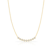 A Diamond Arc Layering Necklace in yellow gold on a white background. 