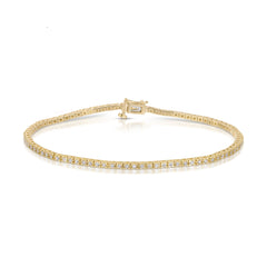 A Down the Line Bracelet in yellow gold on a white background. 
