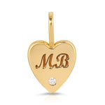 An Engraved Heart Charm on a white background. 