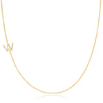A yellow gold necklace with a pave letter W charm on a white background. 