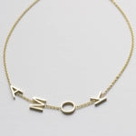 A yellow gold Custom Gold Bracelet – 4 Letters with the letters A, M, O and K on a white background.
