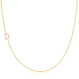 A yellow gold necklace with a pave letter D charm on a white background. 