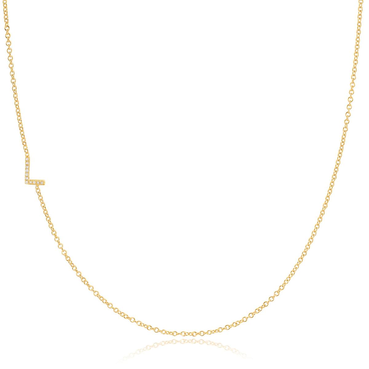 A yellow gold necklace with a pave letter L charm on a white background. 