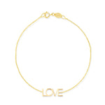 A yellow gold Love Bracelet on a white background. 