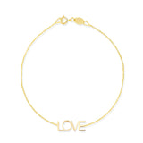 A yellow gold Love Bracelet on a white background. 
