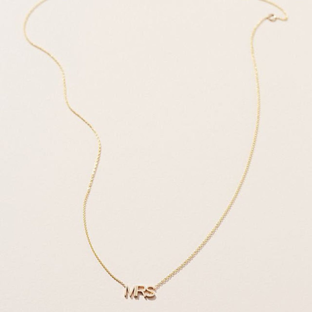 A MRS Necklace in yellow gold on a cable chain on a white background. 