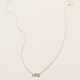A MRS Necklace in yellow gold on a cable chain on a white background. 