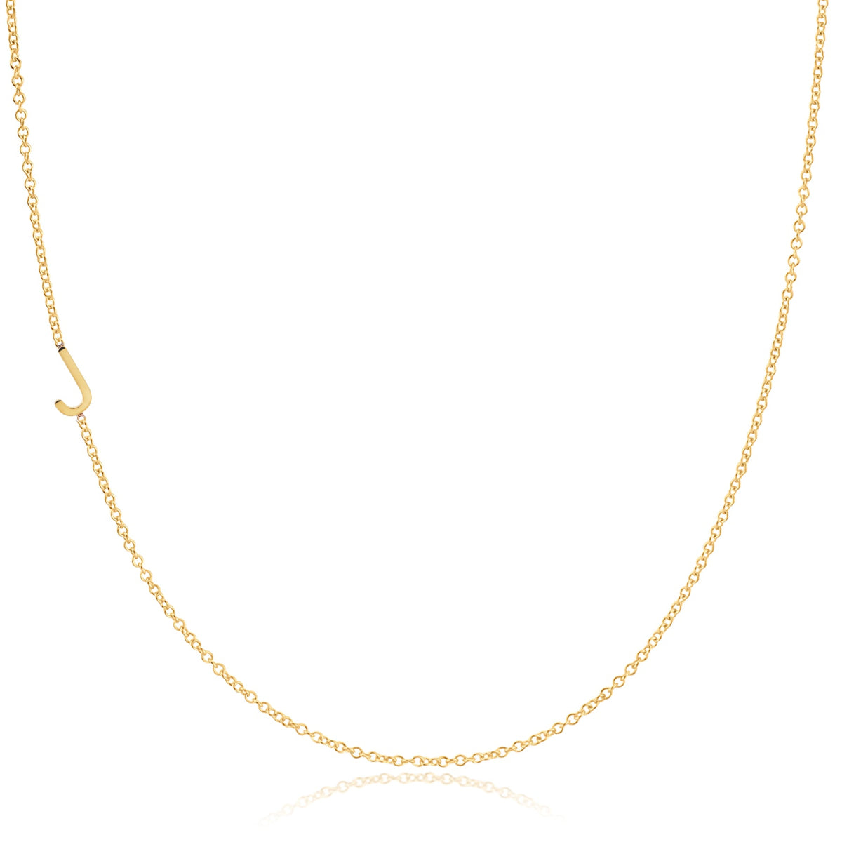 A yellow gold necklace with a J letter charm on a white background. 